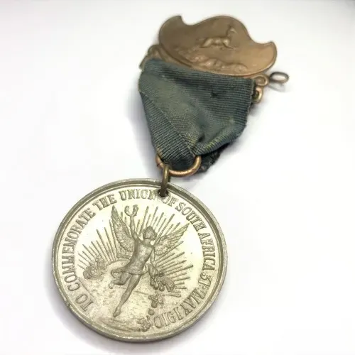 1910 Union of South Africa commemoration medallion with springbok clip