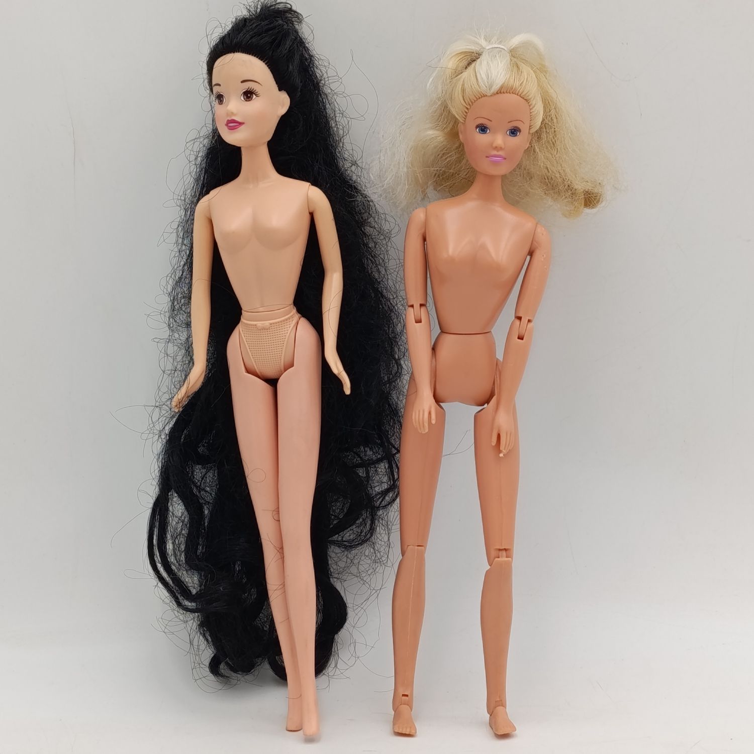 Two dolls with matted hair