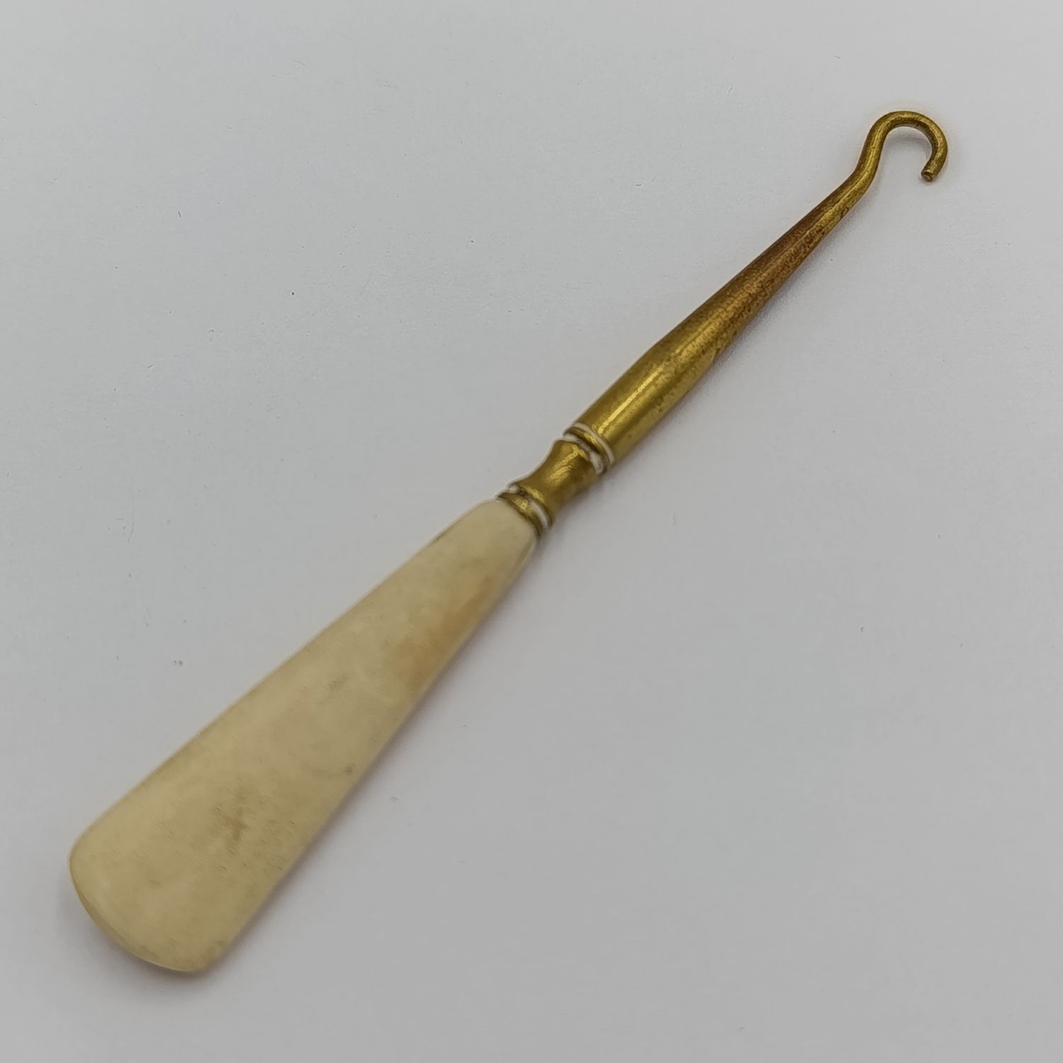 Antique brass bootlace puller with bone handle