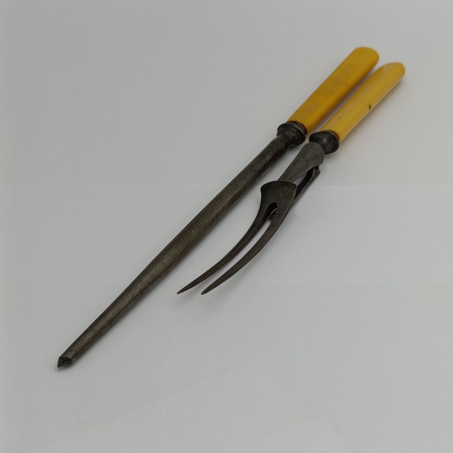 Vintage carving fork and sharpening stick with imitation bone handle