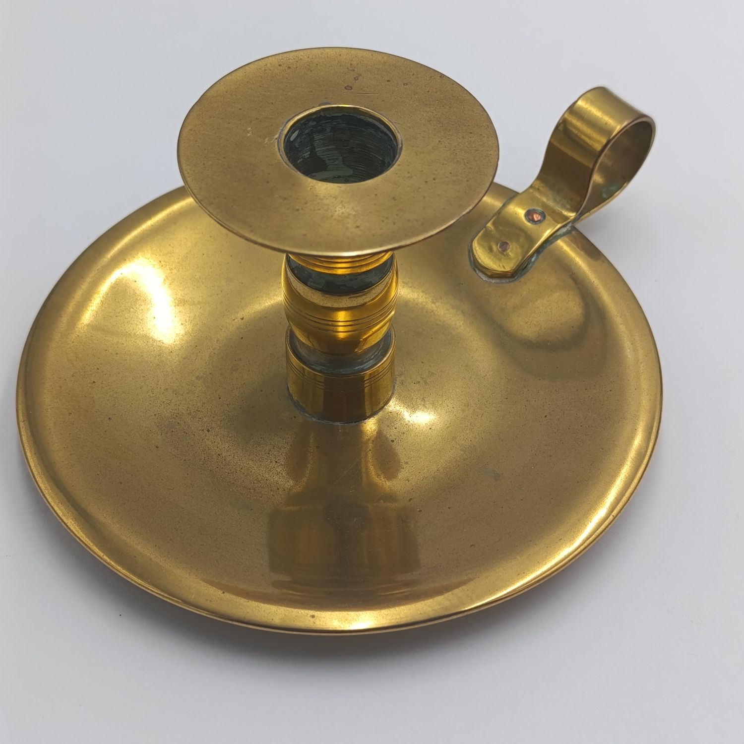 Antique brass candle holder - inscribed at bottom