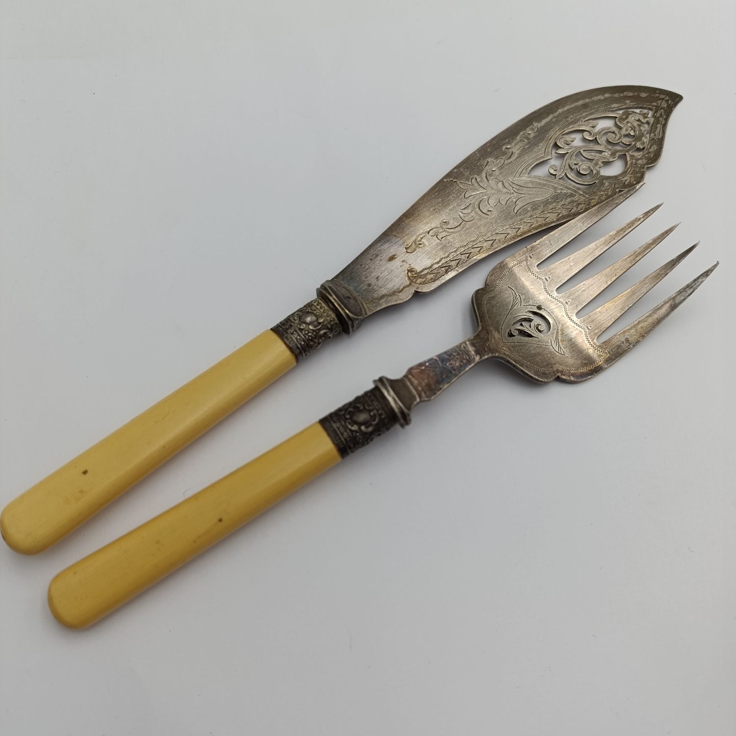 Antique fish serving set with silver trimming with imitation bone handles