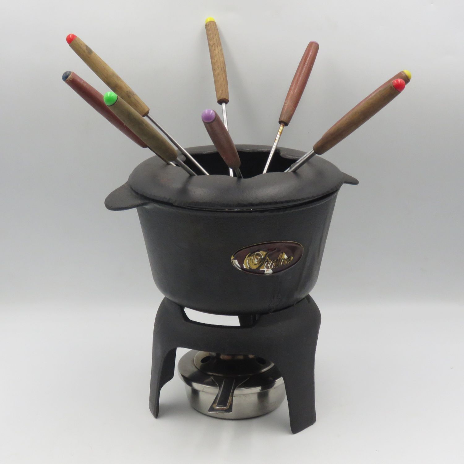 Vintage cast-iron fondue set with 8 forks