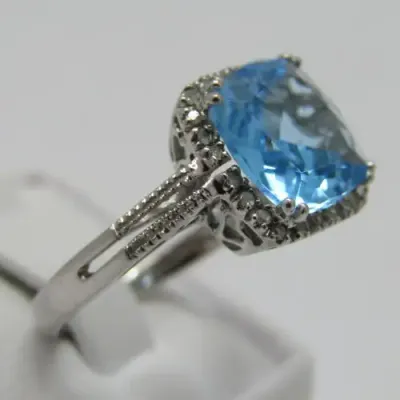 9kt Gold ring with blue Topaz and small diamonds of 0.13ct - weighs 3.5g - size N/7 - new never worn