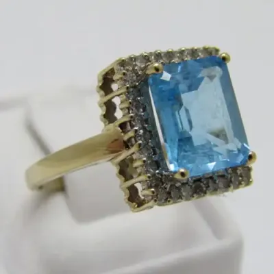 9kt Gold ring with 3.5ct blue topaz and small diamonds of 0.28ct in total - weighs 4.8g - size O/7