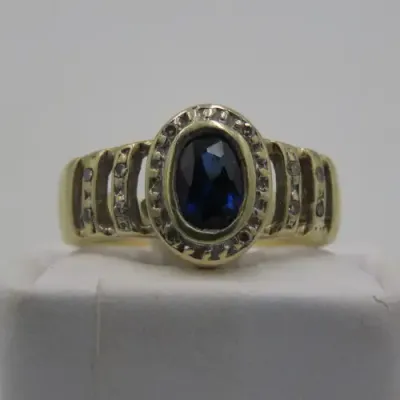 9kt Gold ring with 12 Diamonds and center stone dark blue ( Ring Size - K 1/2)