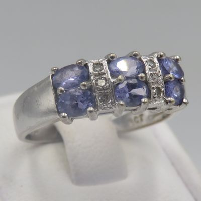9kt white gold ring with 6 small diamonds and 6 Iolites. Weight 3.5g, Size O