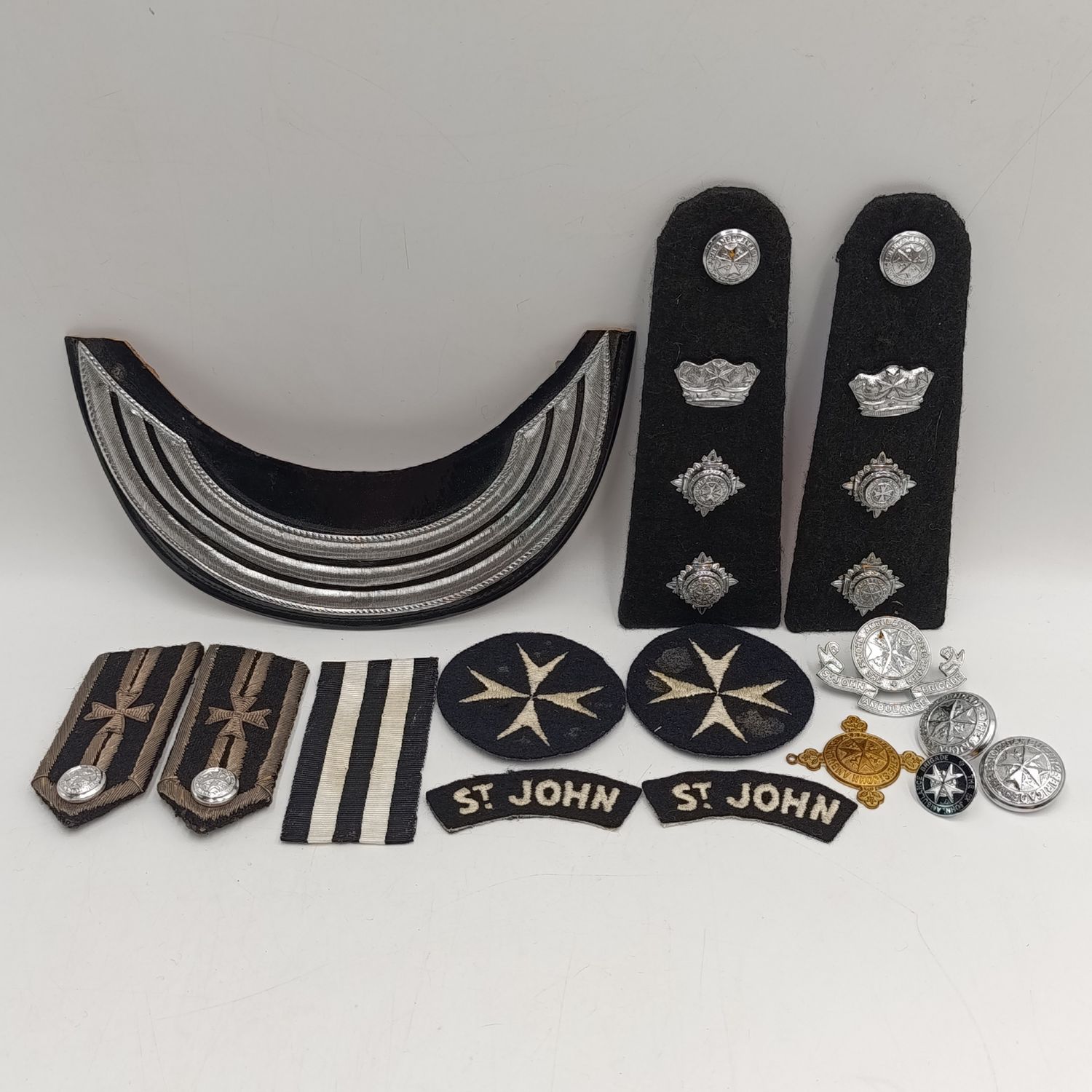 Collection of vintage St. John Ambulance badges and insignia