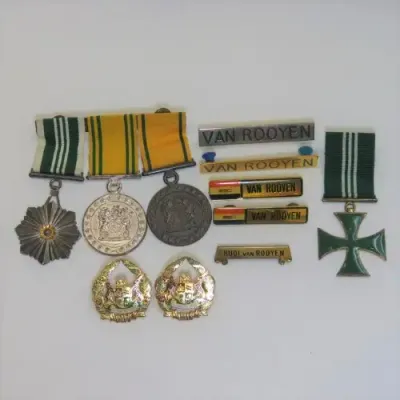 Set of SA Prison Service medals and badges issued to Warrant officer RJ. Van Rooyen