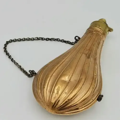 Antique red and yellow copper gun powder flask