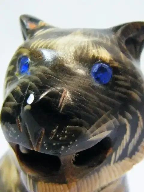 Beautiful carved tiger figurine with blue stone eyes - carved from horn