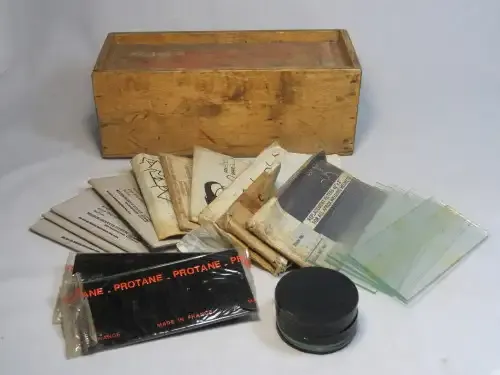 Wooden box with lot of vintage welding helmet filter lenses