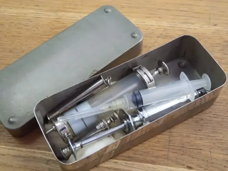 Vintage metal case with syringes