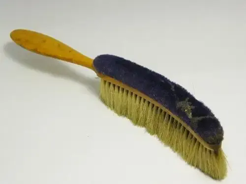 Antique wooden clothing brush with material backing