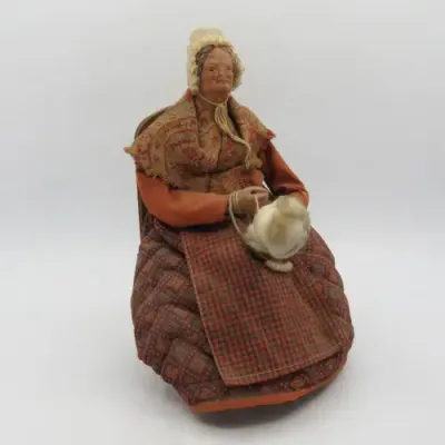 Antique French Santon clay grandma doll on chair