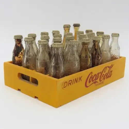 Vintage miniature Coca-Cola bottles in yellow tray - Two Coke bottles missing and was replaced