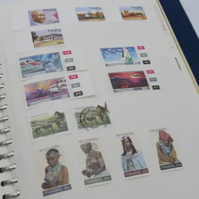 Album with over 1100 stamps including Transkei and Venda mint collections and a lot of USA stamps