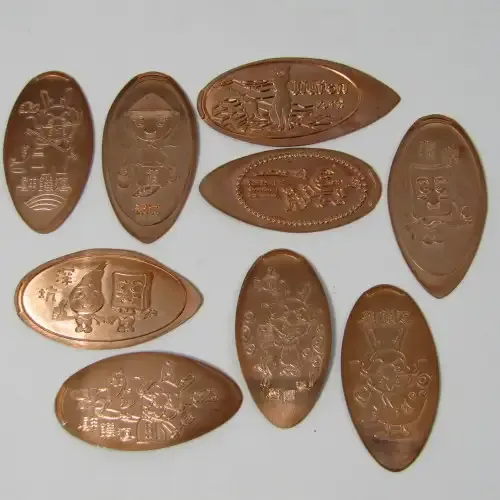 Lot of 9 elongated coins with comic / anime characters