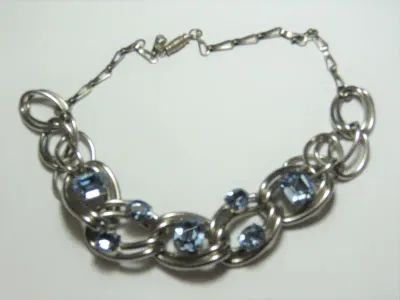 Set of costume jewellery necklace and clip-on earrings with blue stones