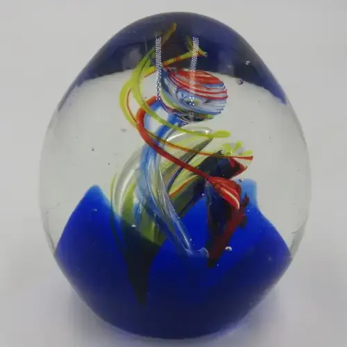 Handmade glass paperweight with spiral design