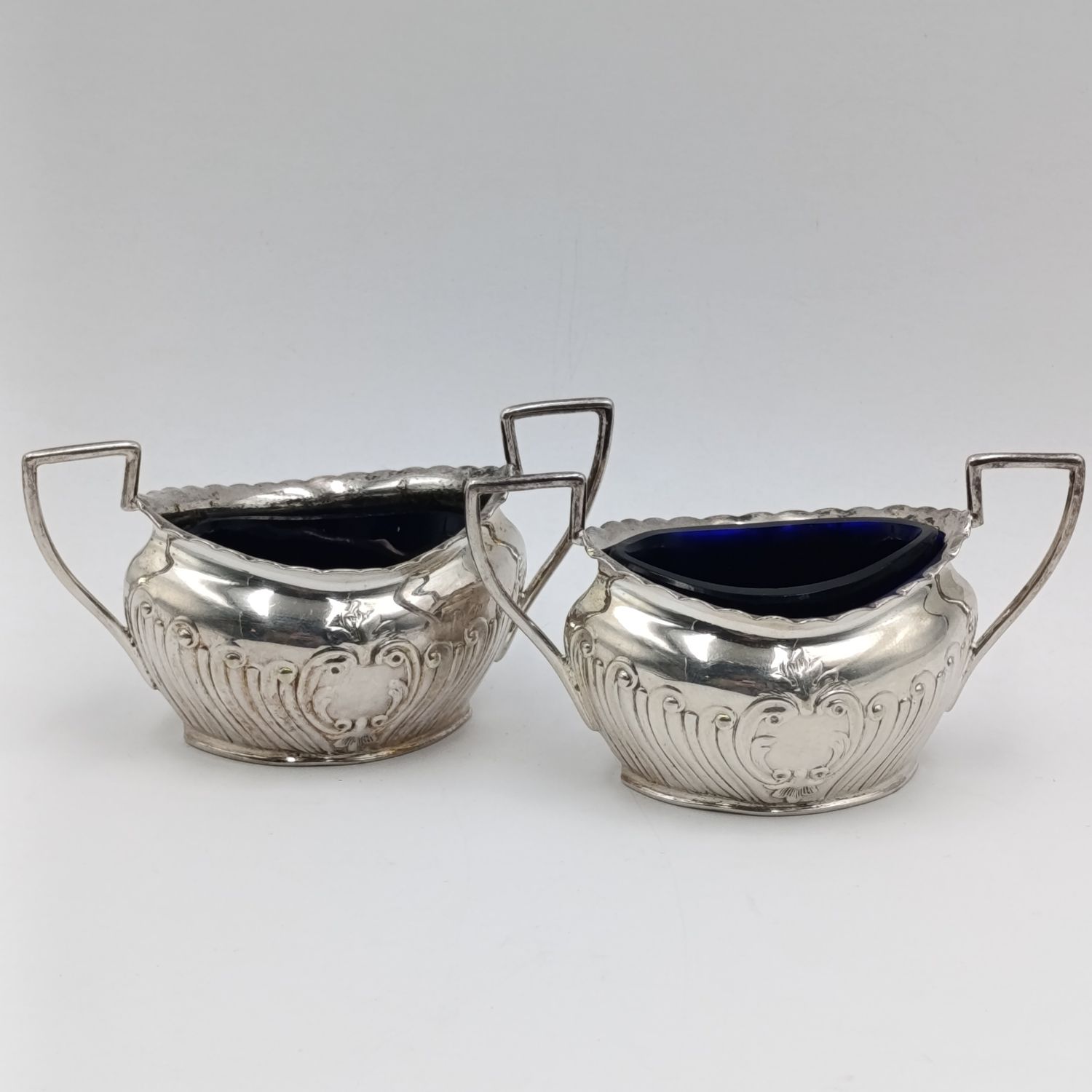 Pair of antique silverplated salt cellars with glass inners