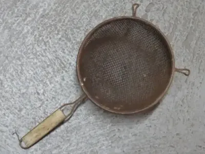 Vintage flour sieve with wooden handle