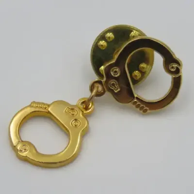 Police handcuffs pin badge