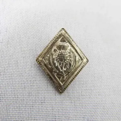 The Camarodians (The Scottish rifles) white metal button made by Wilkenson Sword company