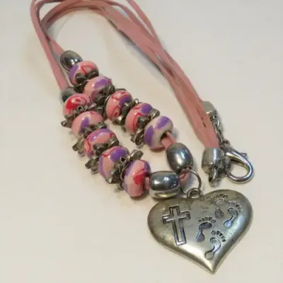 Costume jewellery pink necklace with cross pendant