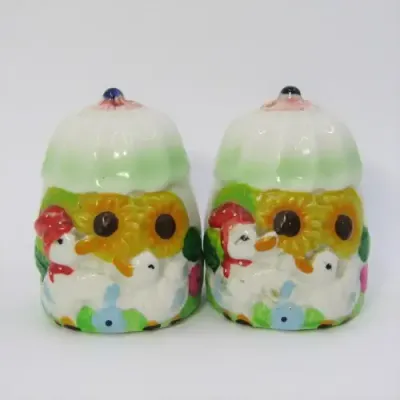 Pair of porcelain salt and pepper shakers with ducks and flowers