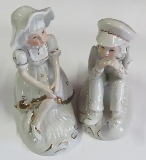 Pair of porcelain boy and girl figurines