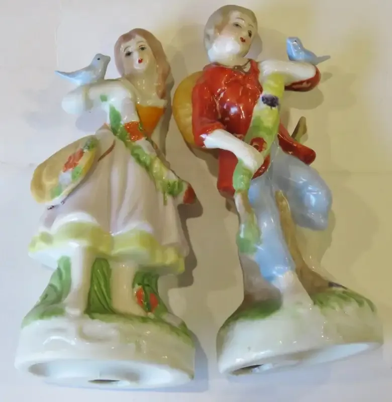 Pair of boy and girl with birds porcelain figurines