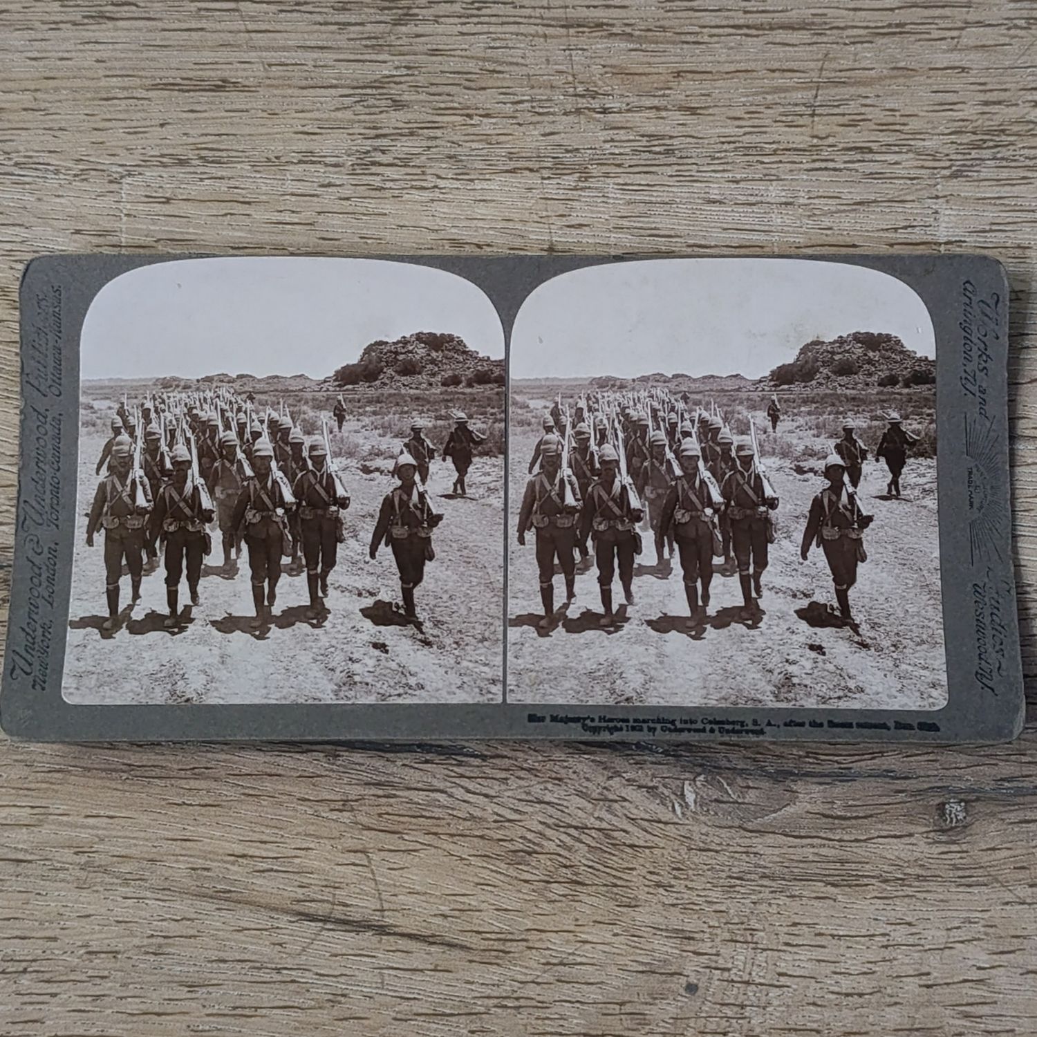 Boer War stereoscope card - Her Majesty's Heroes marching into Colesberg, S.A after the Boers retreat