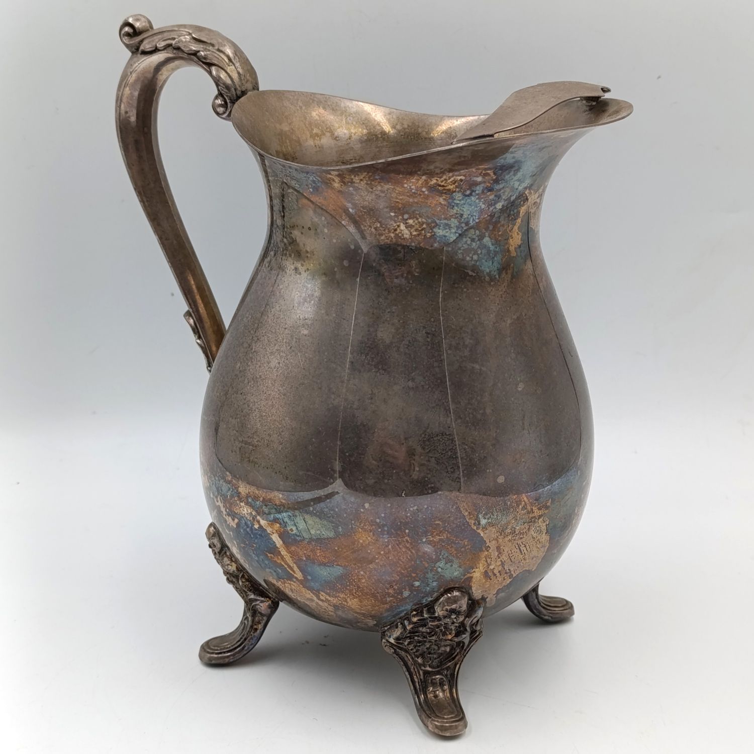 Antique silverplated pitcher with ice stopper
