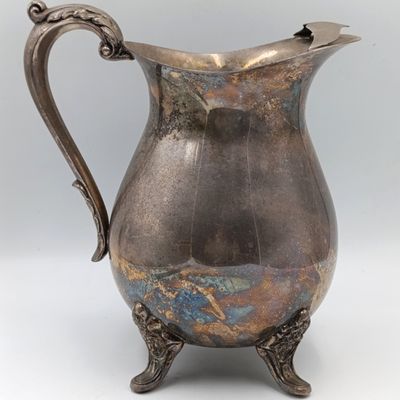 Antique silverplated pitcher with ice stopper