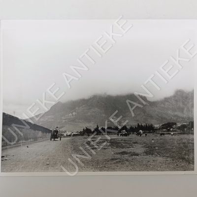 Antique photo reprint of horse cart next to Castle of Good Hope wall with Devils Peak in back