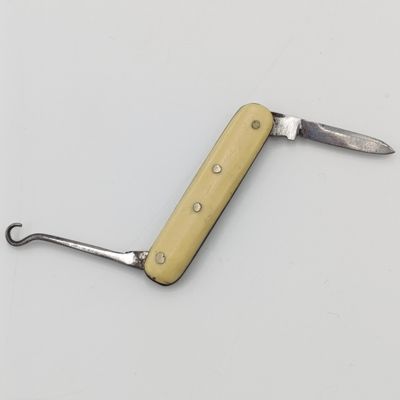Vintage miniature pocket knife with bootlace puller