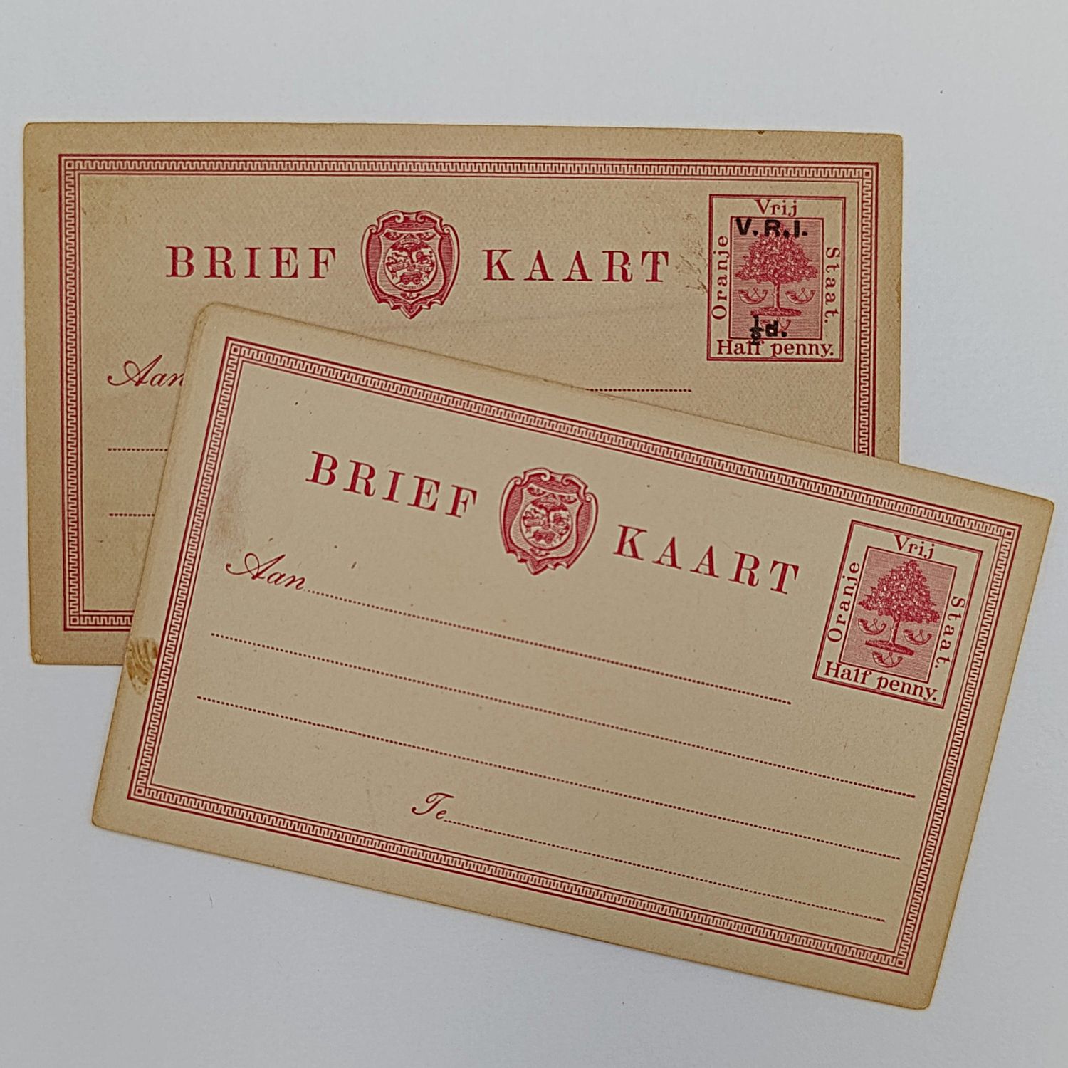 Pair of Oranje Vrij Staat Postcards with pre printed postage - one before and one after British Occupation