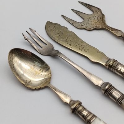 Lot of 4 cutlery items - vintage with mother-of-pearl handles - one with sterling silver surround