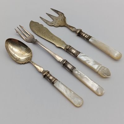 Lot of 4 cutlery items - vintage with mother-of-pearl handles - one with sterling silver surround