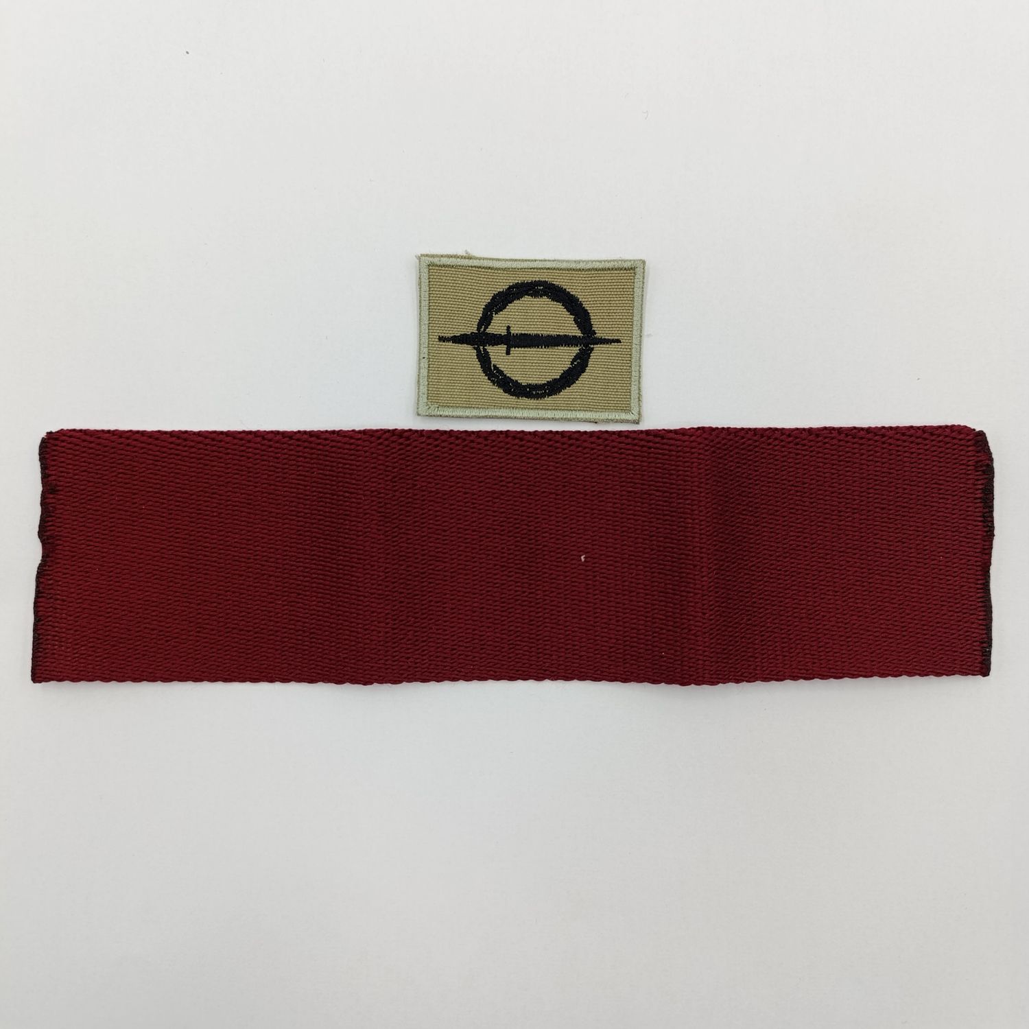 SANDF Special Forces Operator cloth badge with piece of Maroon stable belt material