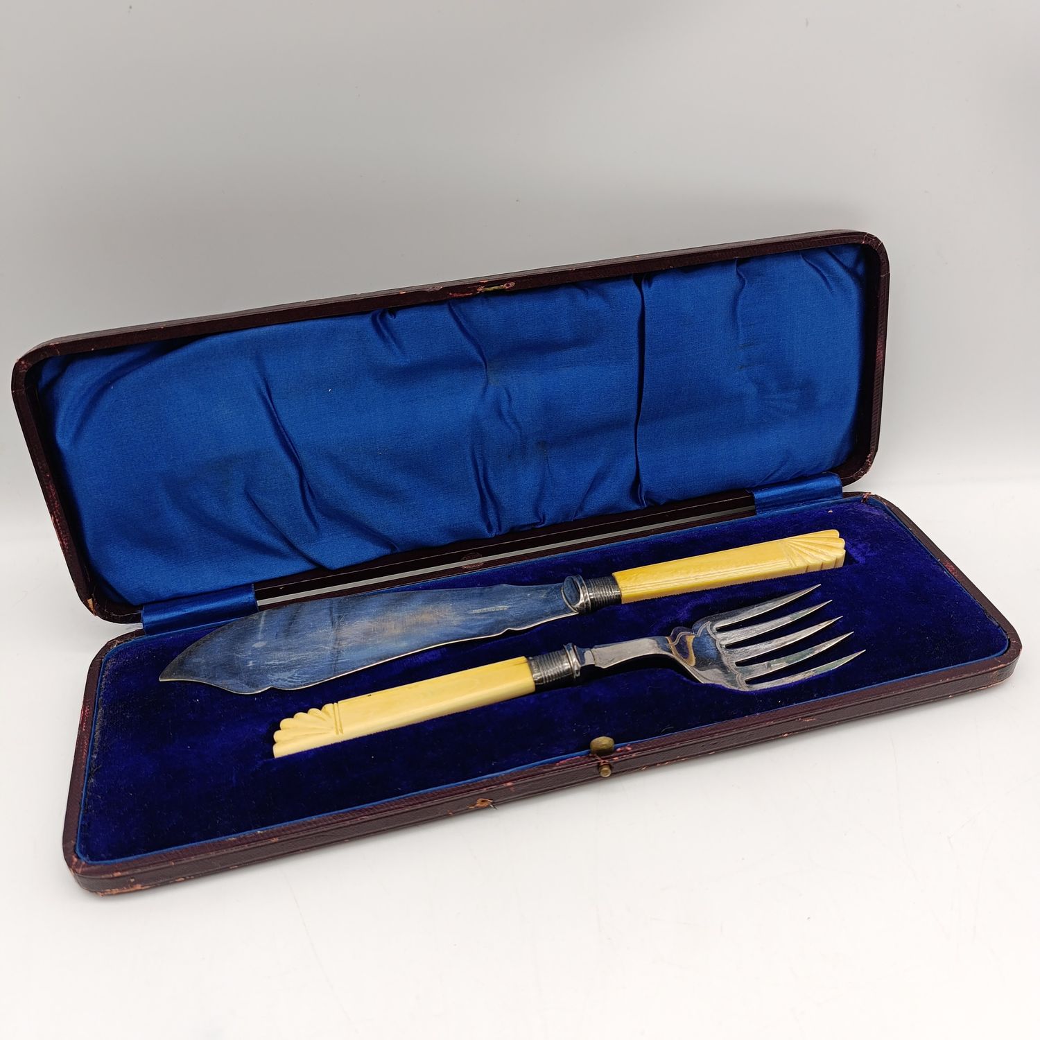 Antique fish serving set with faux ivory handles and hallmarked silver trimmings