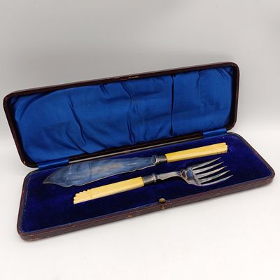 Antique fish serving set with faux ivory handles and hallmarked silver trimmings