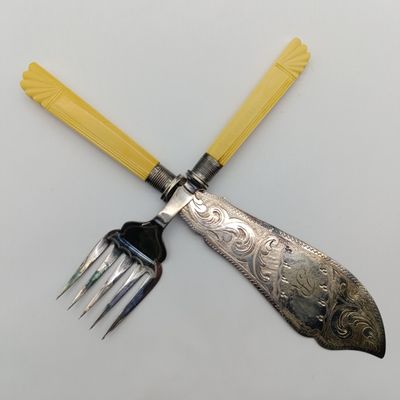 Antique fish serving set with faux ivory handles and hallmarked silver trimmings