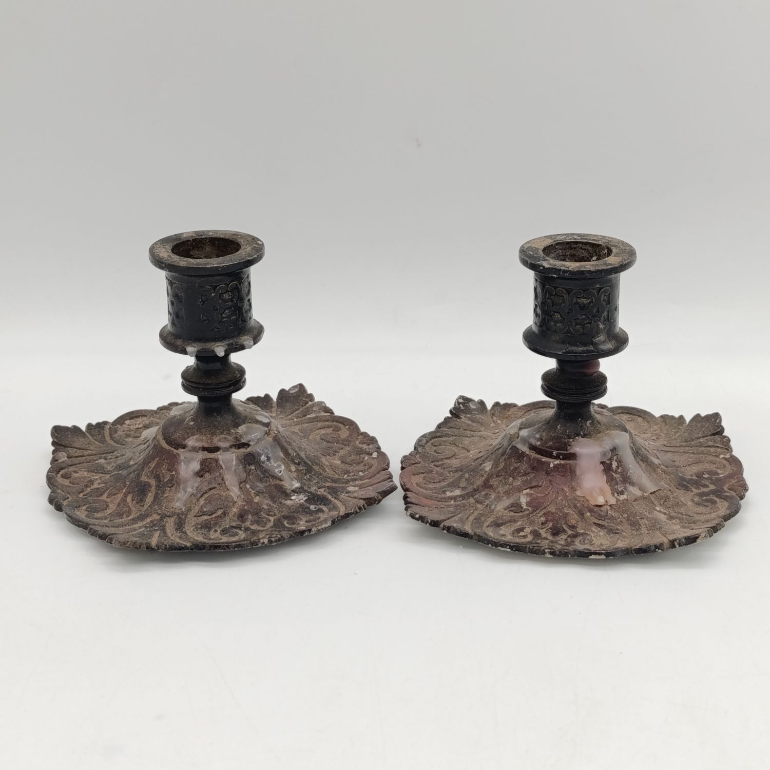 Pair of antique cast iron candle holders