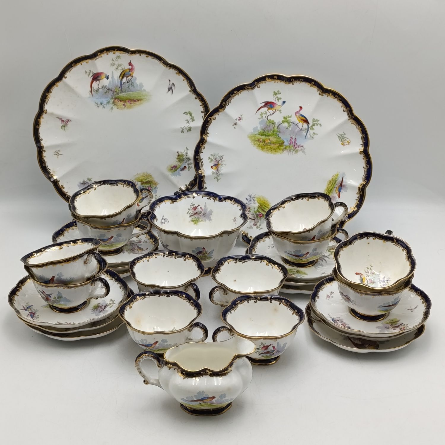 Antique Crescent George Jones and sons porcelain tea set - 12 cups, 12 Plates (1 with faint chip), milk jug, sugar bowl and 2 serving platters