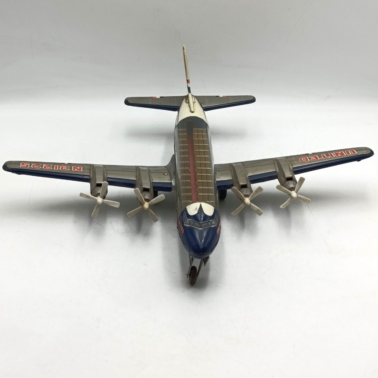 Vintage United Airlines DC-7 Mainliner friction toy airplane - wheel repaired