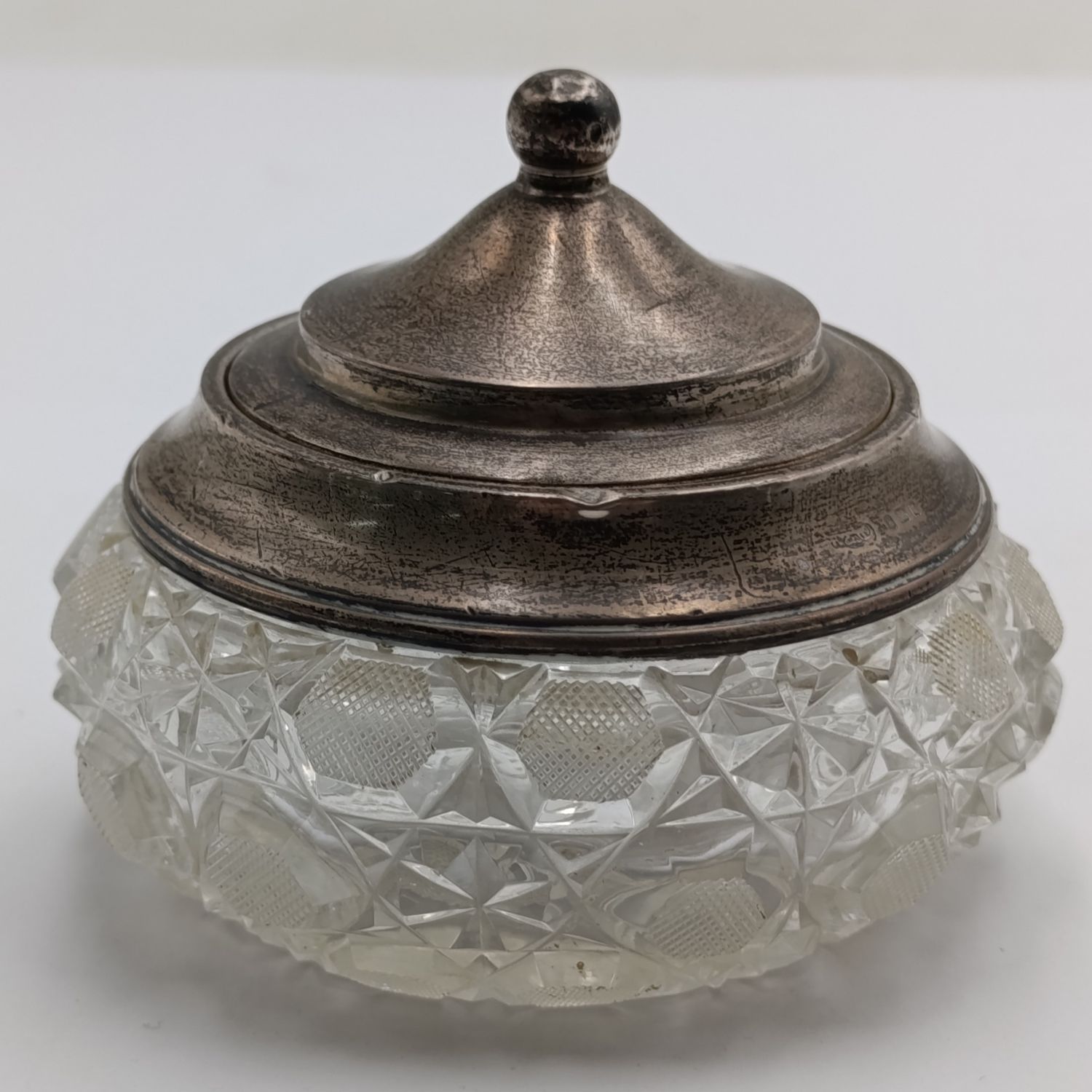 Cut glass vessel with sterling silver rim and lid