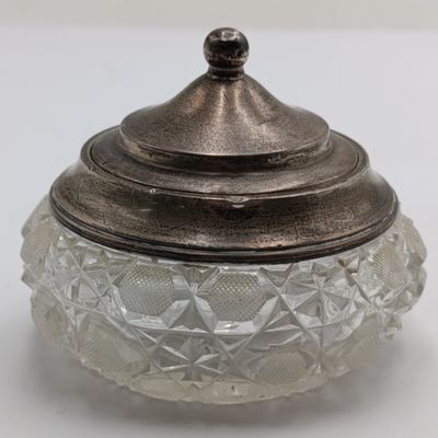 Cut glass vessel with sterling silver rim and lid