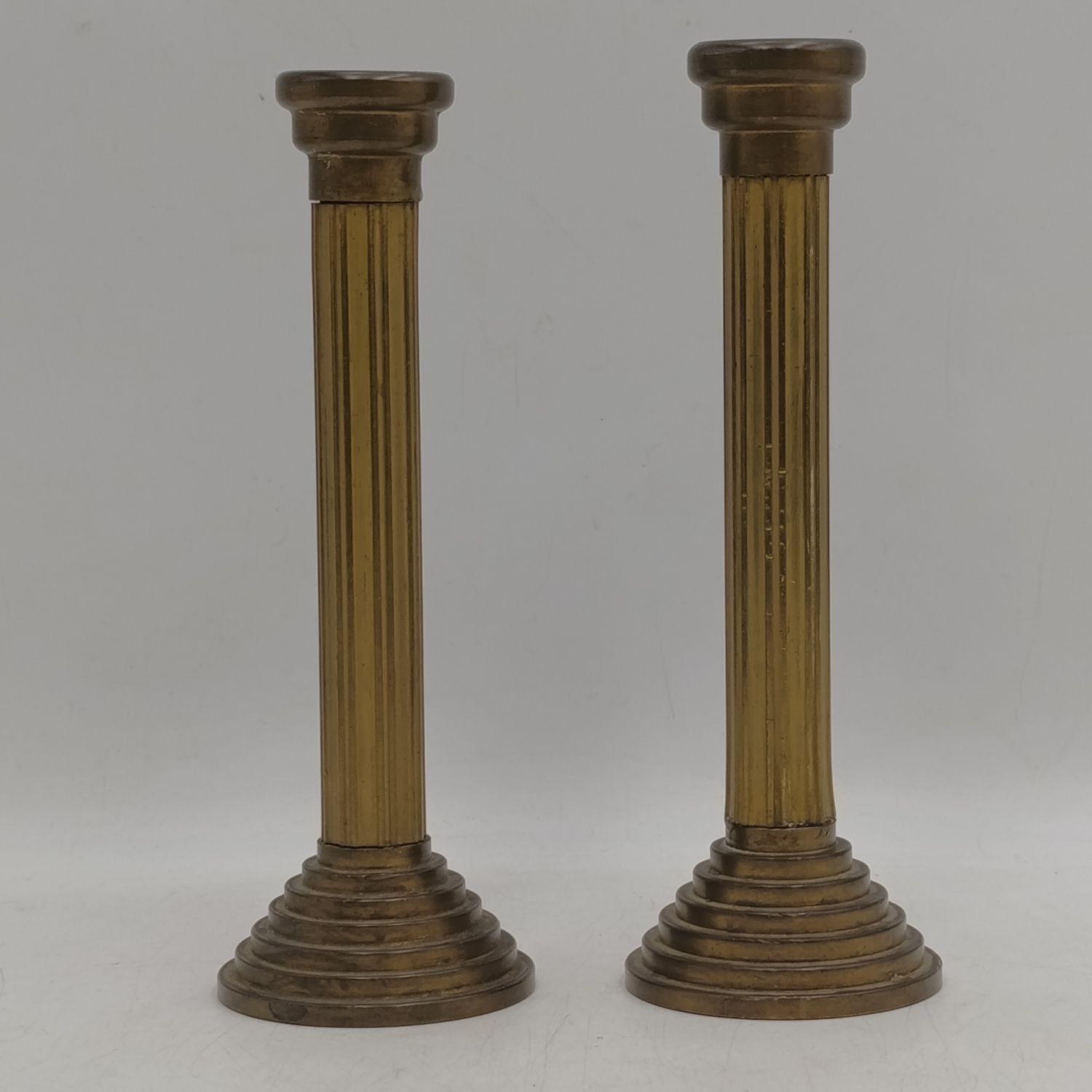 Pair of brass Roman pillar candle sticks - Height 21cm